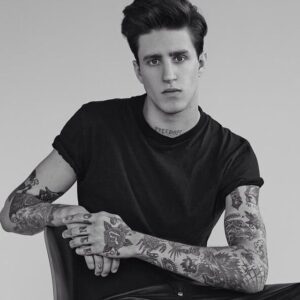 Miles Langford portrait showcasing full tattoo sleeves and neck tattoo