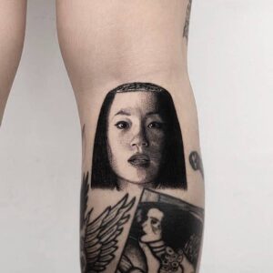 Realistic Lucy Liu portrait tattoo on leg inspired by Kill Bill O-Ren Ishii character