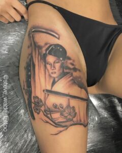 Lucy Liu inspired geisha tattoo on thigh featuring katana sword and cherry blossoms