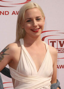 Alicia Goranson visible tattoo on right bicep in casual outfit